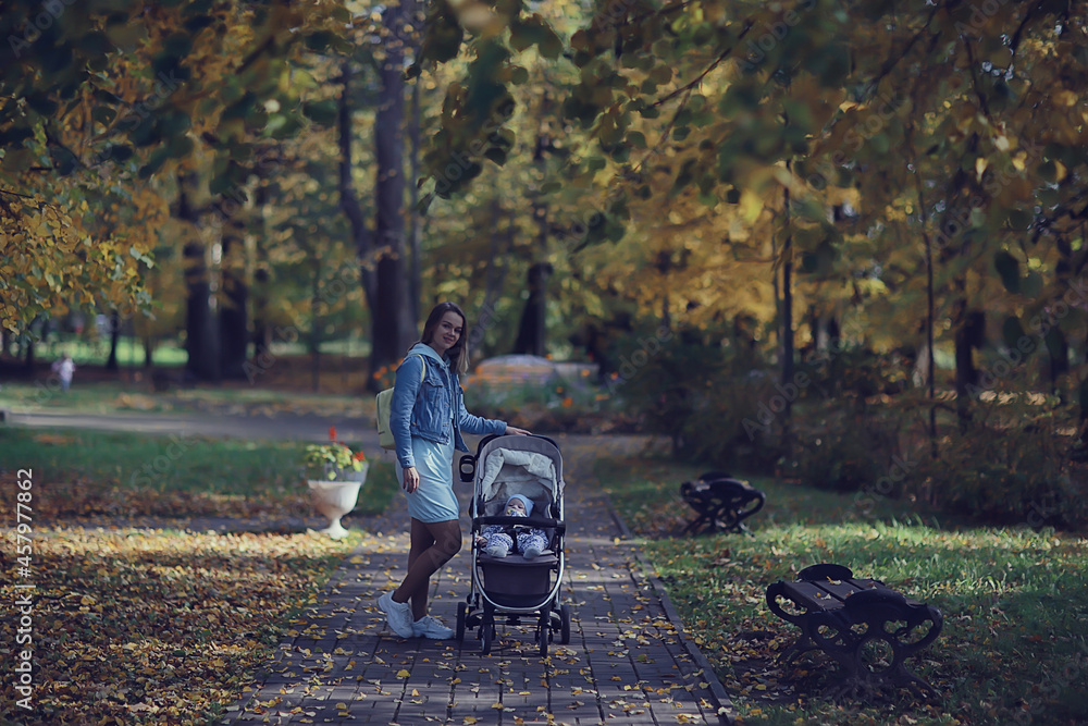 mom with a stroller in the autumn park for a walk, landscape autumn view october alley yellow park mom with a stroller in the autumn park for a walk, landscape autumn view october alley yellow park