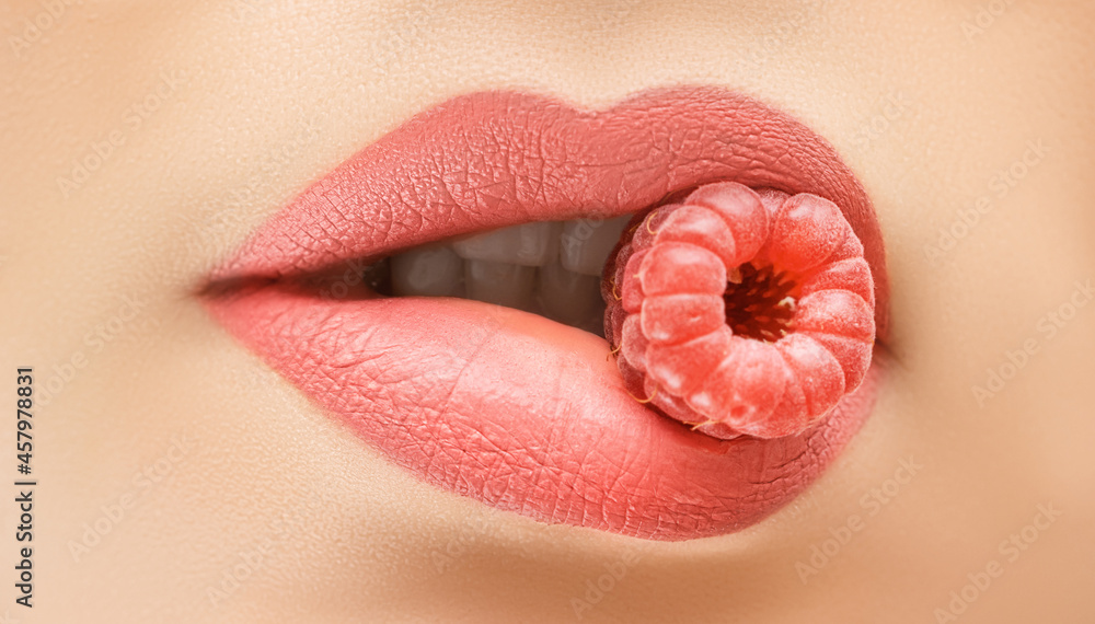 Perfect female lips. Close up female lips with raspberry. Raspberry color female lips with