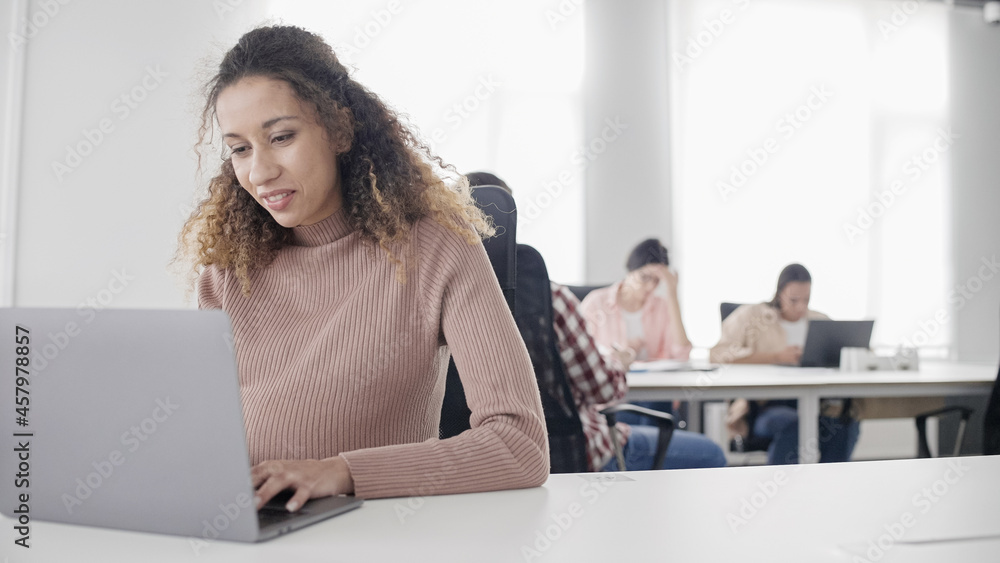 Young pregnant woman working on laptop in office, motherhood, work during pregnancy Young pregnant woman working on laptop in office, motherhood, work during pregnancy