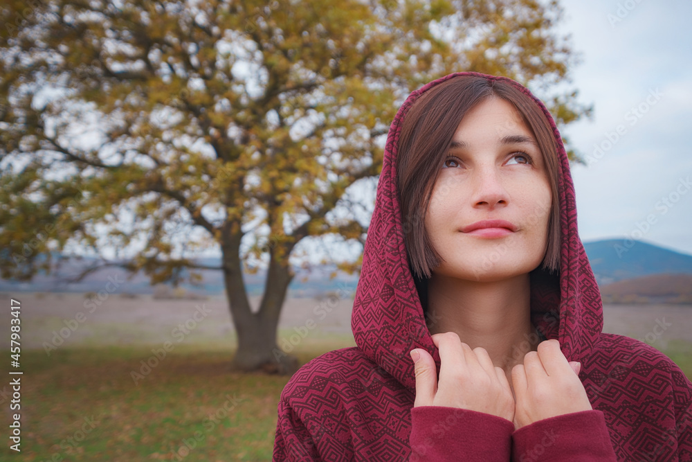 Portrait of a young woman in hoodie in the nature Portrait of a young woman in hoodie in the nature