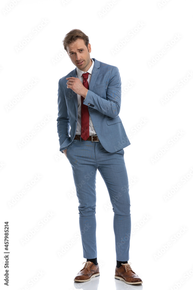 attractive young businessman in blue suit holding hand in pocket attractive young businessman in blue suit holding hand in pocket