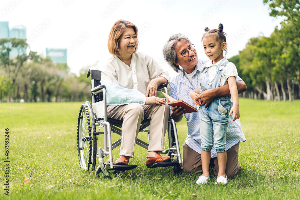 Portrait of happy love asian grandfather with grandmother and asian little cute girl enjoy relax in summer park.Young girl with their laughing grandparents smiling together.Family and togetherness Portrait of happy love asian grandfather with grandmother and asian little cute girl enjoy relax in summer park.Young girl with their laughing grandparents smiling together.Family and togetherness