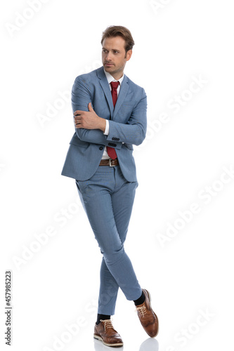 sexy elegant young man crossing arms and looking to side