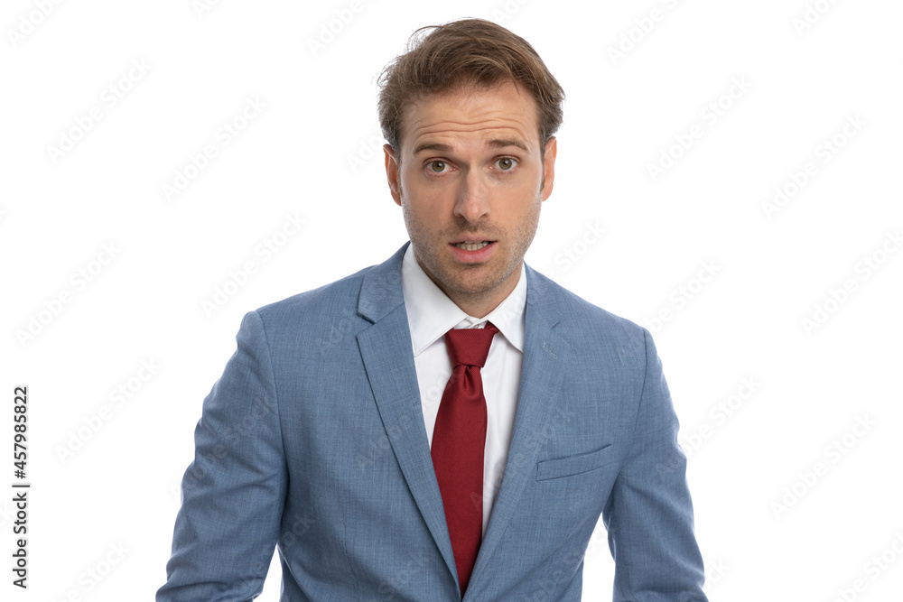 shocked young businessman in blue suit making a surprised face shocked young businessman in blue suit making a surprised face