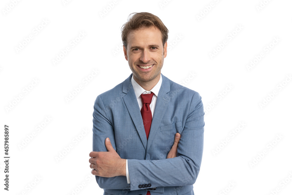 young elegant businessman in blue suit crossing arms and smiling young elegant businessman in blue suit crossing arms and smiling