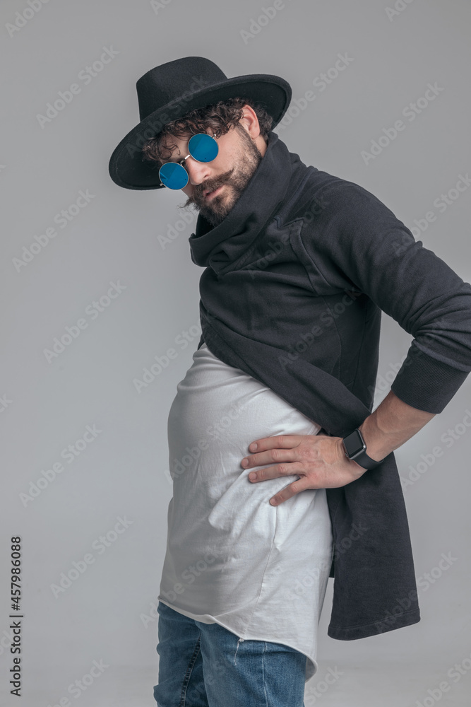 handsome casual man flexing his belly and being carefree handsome casual man flexing his belly and being carefree