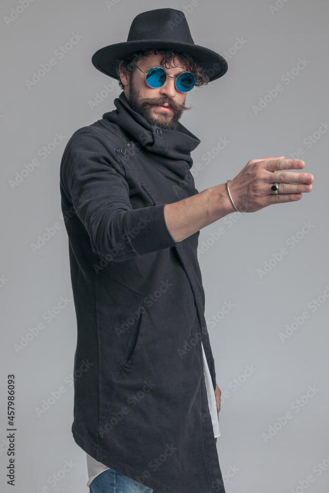sexy casual man posing with one arm raised sexy casual man posing with one arm raised