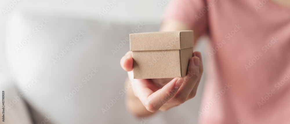 Close up of woman hands holding a small gift box. Small present box in the woman hands.. Close up of woman hands holding a small gift box. Small present box in the woman hands..