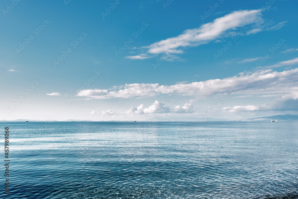 Obraz premium Minimalistic seascape with sea, sky and clouds