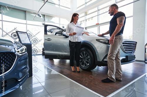 Professional custom service representative talking to her client photo