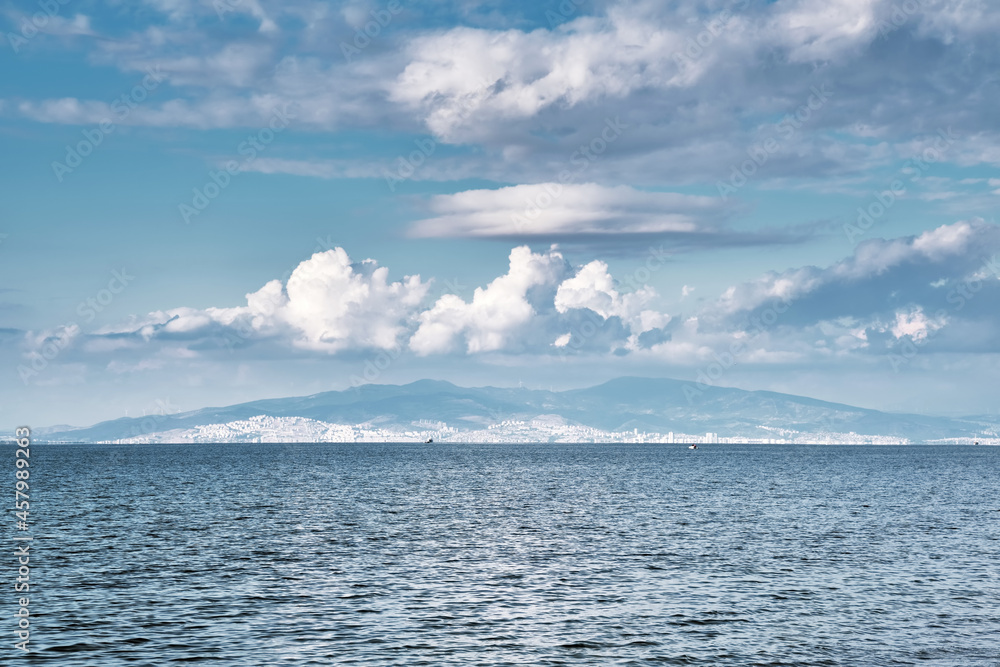 Minimalistic seascape with sea, sky, sand and an island at the horizon. Minimalistic seascape with sea, sky, sand and an island at the horizon.