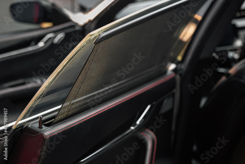 Car rear window side curtain. Sunblind curtain in a modern luxury car. Passenger door. Selective focus. © Oleksandr