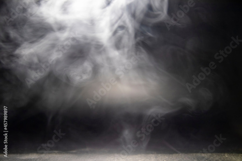 Blurry motion of smoke. Abstract design of white cloud on a dark background. Blurry motion of smoke.
