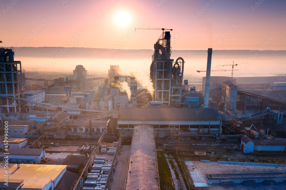Industrial plant at sunrise in the fog