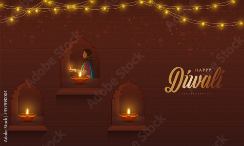 Indian Woman Decorated Windows From Lit Oil Lamps (Diya) And Lighting Garland On Brown Background For Diwali Celebration.