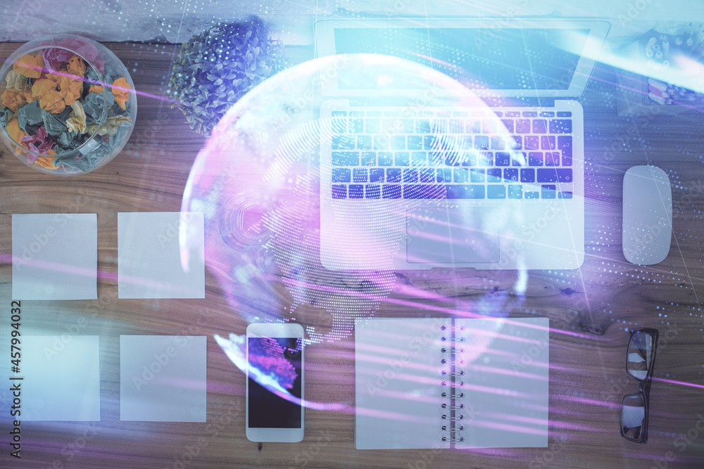 Technology hologram drawing over computer on the desktop background. Top view. Double exposure. Tech concept. Technology hologram drawing over computer on the desktop background. Top view. Double exposure. Tech concept.