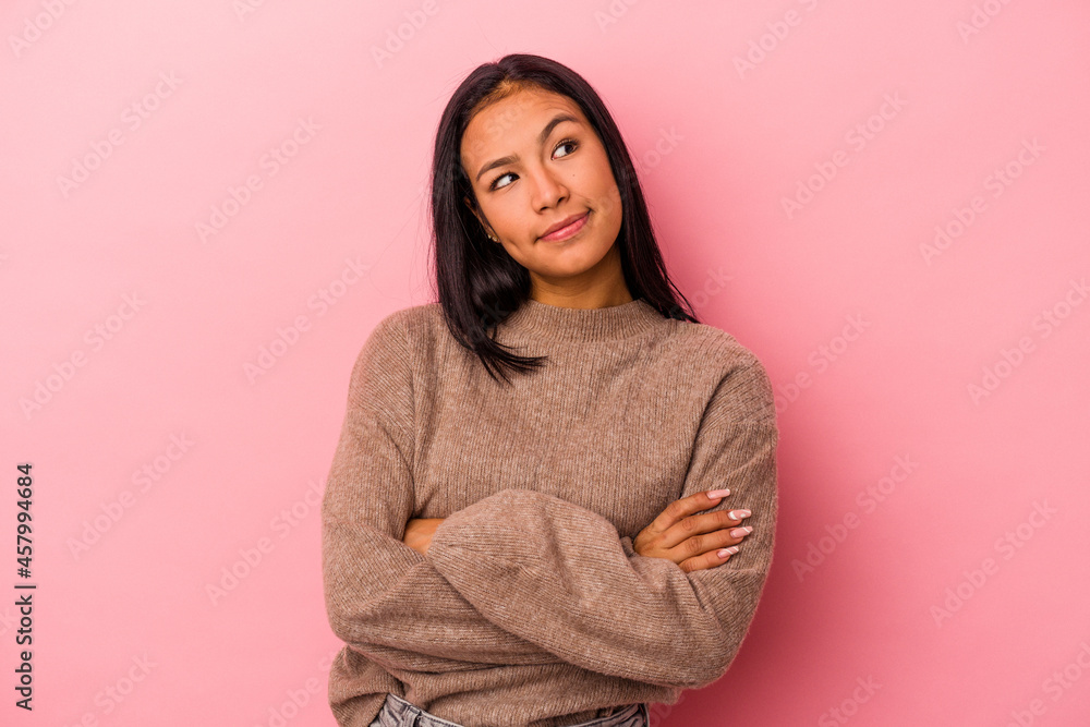 Young latin woman isolated on pink background dreaming of achieving goals and purposes Young latin woman isolated on pink background dreaming of achieving goals and purposes
