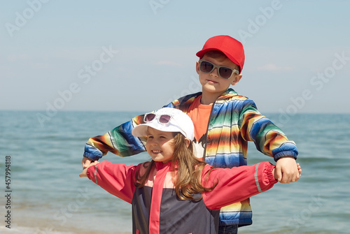 Children at the sea on a cool sunny day