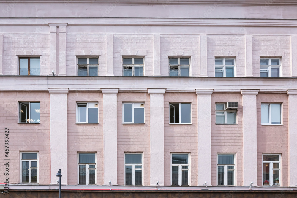 Fototapeta premium Vintage architecture classical fscade house. Simple pink building front view.