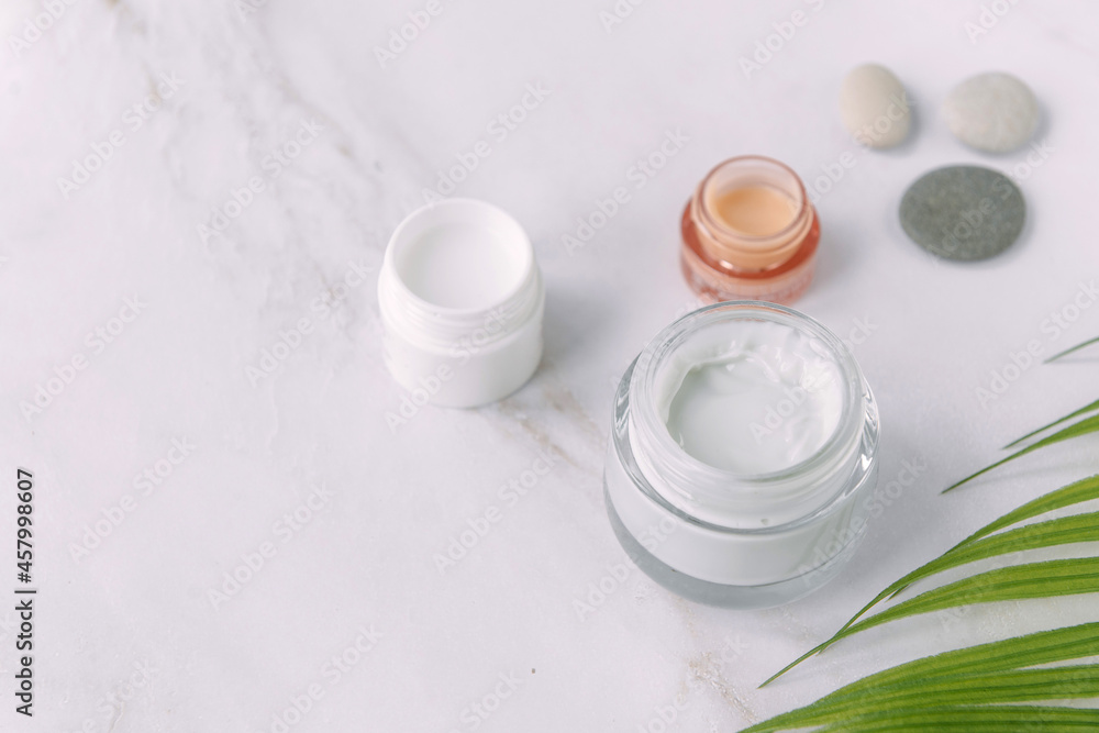 little pot of face cream palm tree leaf - beauty and spa concept little pot of face cream palm tree leaf - beauty and spa concept