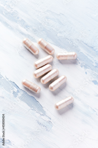 Carnitine capsules. Concept for a healthy dietary supplementation. Bright wooden background. Soft focus. Close up. Copy space. 