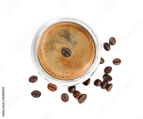 Cup of tasty coffee and beans isolated on white, top view