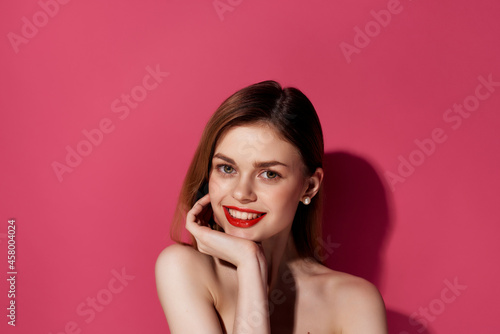 beautiful woman in a black dress pink background