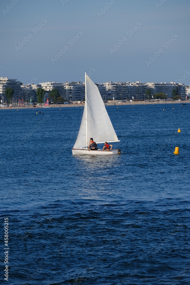 Obraz premium A sailing boat in the bay of la Baule. The 12th august 2021, le Pouliguen, France.