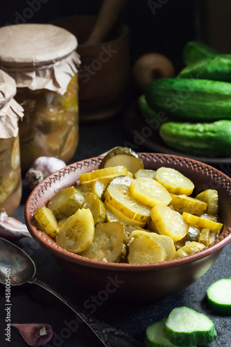 Pickled cucumber salad in a bowl and jars
