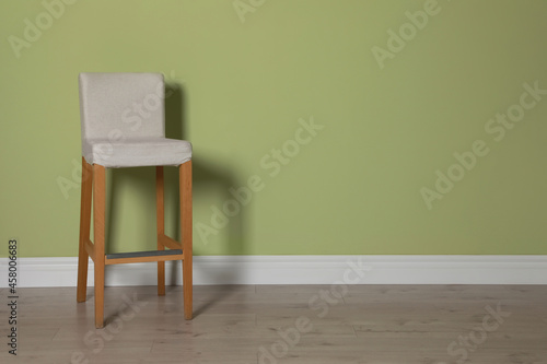 Fototapeta Naklejka Na Ścianę i Meble -  Stylish bar stool near light green wall indoors. Space for text