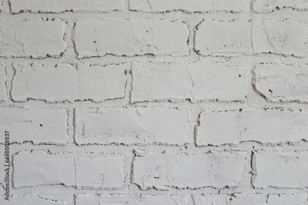 Obraz premium Decorative plaster on the wall in the form of white brickwork close-up