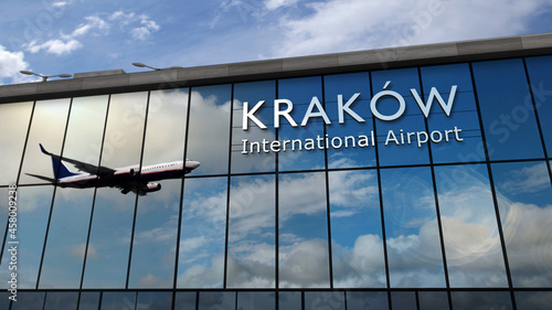 Airplane landing at Krakow, Cracow Poland airport mirrored in terminal photo