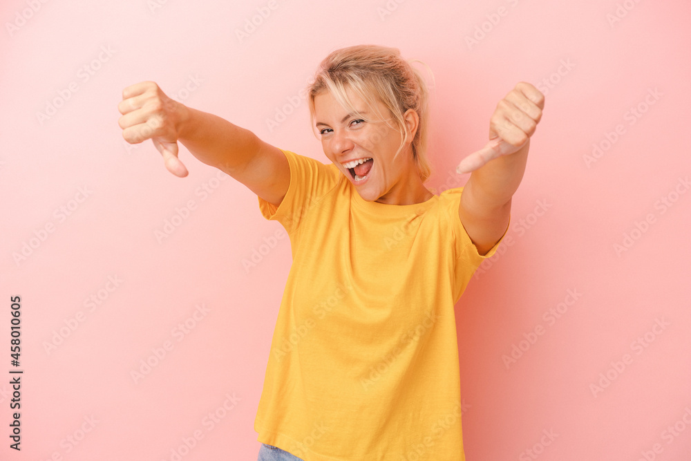 Young Russian woman isolated on pink background raising both thumbs up, smiling and confident. Young Russian woman isolated on pink background raising both thumbs up, smiling and confident.