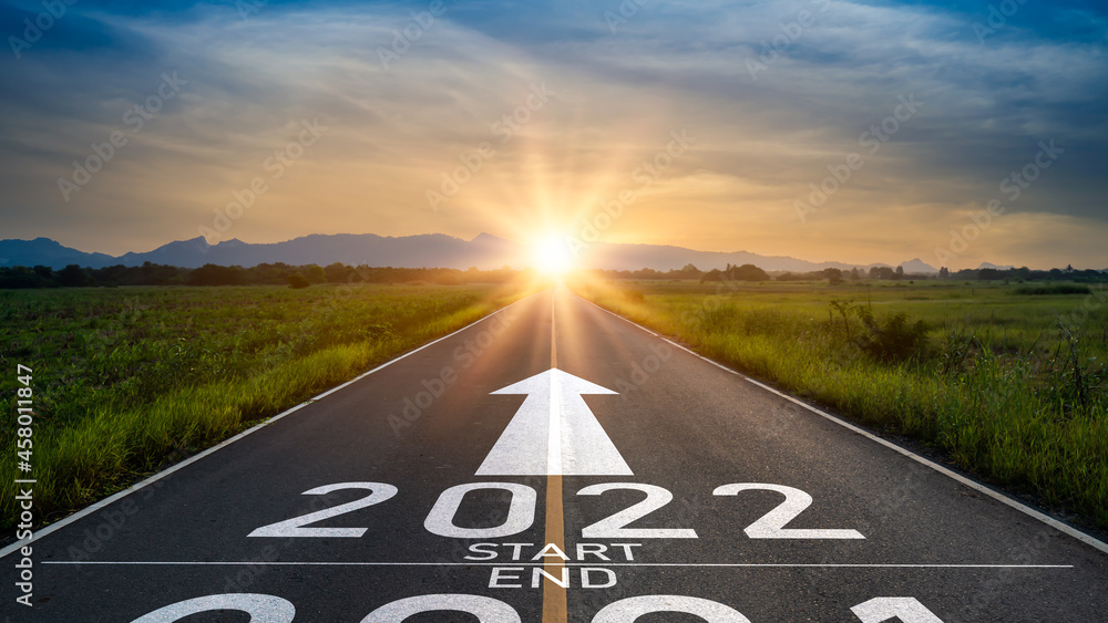 New year 2022 or start straight concept.word 2022 written on the road in the middle of asphalt road at sunset.Concept of planning and challenge or career path,business strategy,opportunity and change - obrazy, fototapety, plakaty 