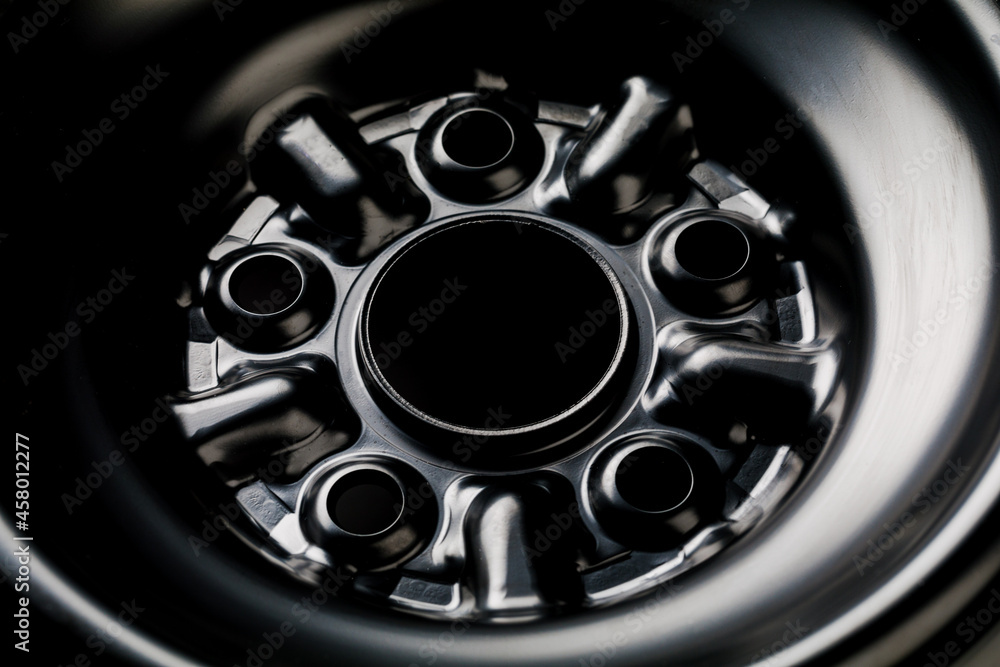 The black element of the car disk. Car wheel close-up.