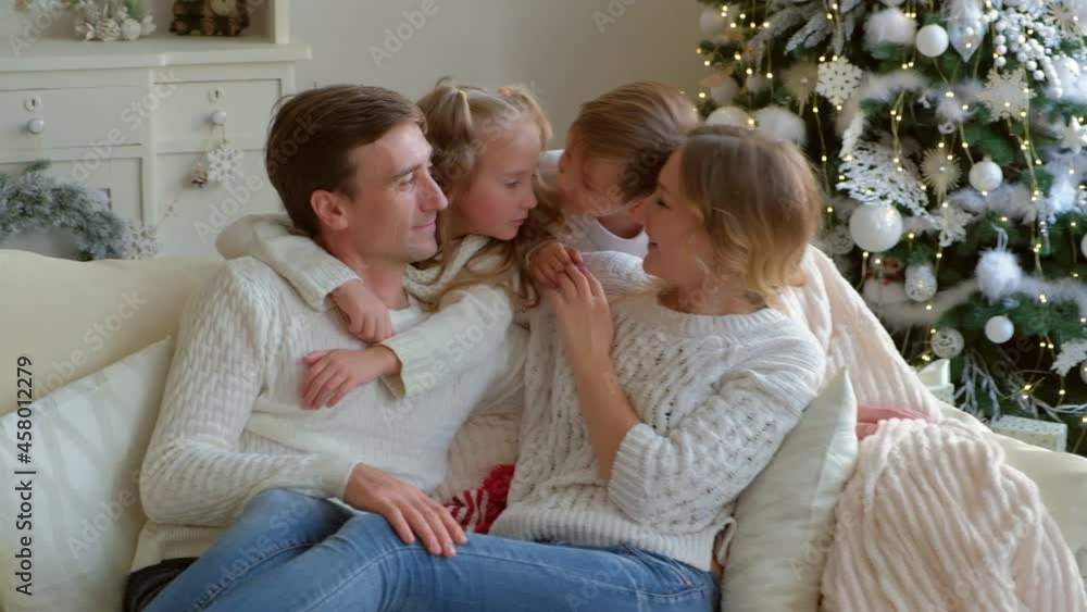 Portrait of beautiful family hugging and kissing on couch. Portrait of beautiful family hugging and kissing on couch.