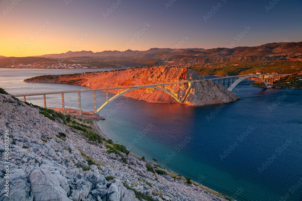 Krk Bridge, Croatia. Image of Krk Bridge which connects the Croatian island of Krk with the mainland at beautiful summer sunset.