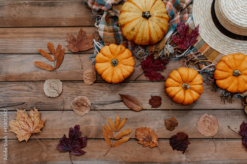 Flat Lay Autumn background decoration from dry leaves and pumpkin on wooden background. Top view for Autumn, fall, Thanksgiving concept.