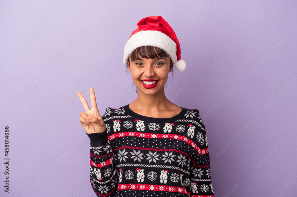 Young mixed race woman celebrating Christmas isolated on purple background  showing number two with fingers.