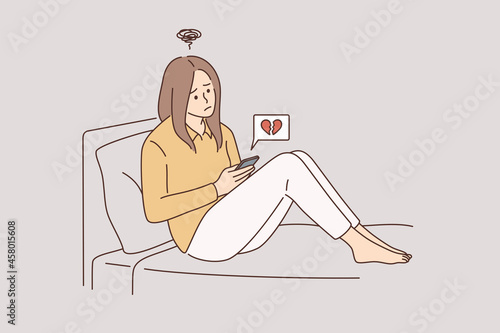 Online dating and broken heart concept. Young unhappy sad disappointed girl cartoon character sitting communicating online with boyfriend breaking up vector illustration