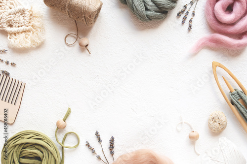 Beautiful layout of materials for macrame, weaving: cotton cords, jute twine, wooden beads. Flat lay.