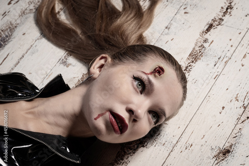 Hit woman. Woman in a latex suit killed in gunfire shot in the head.