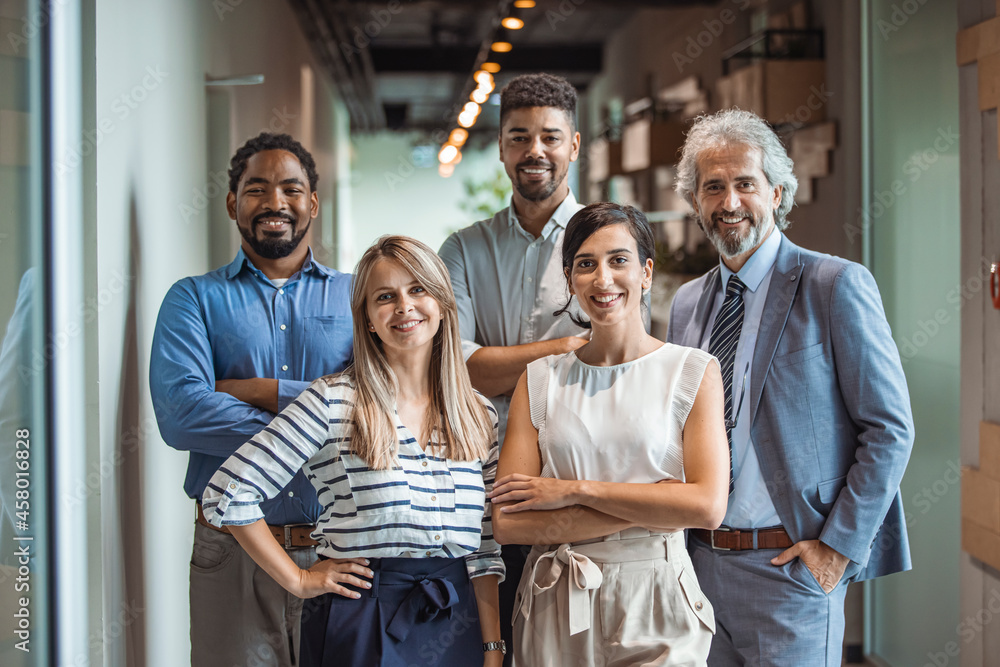 © Dragana Gordic - Shot of a group of well-dressed businesspeople standing together. Successful business team smiling teamwork corporate office colleague. Ready to make success happen © Dragana Gordic - Shot of a group of well-dressed businesspeople standing together. Successful business team smiling teamwork corporate office colleague. Ready to make success happen