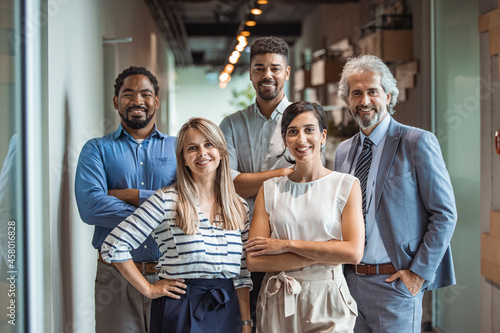 Shot of a group of well-dressed businesspeople standing together. Successful business team smiling teamwork corporate office colleague. Ready to make success happen