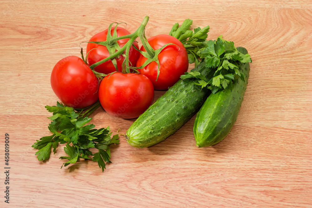 Branch of red tomatoes, cucumbers and parsley twigs