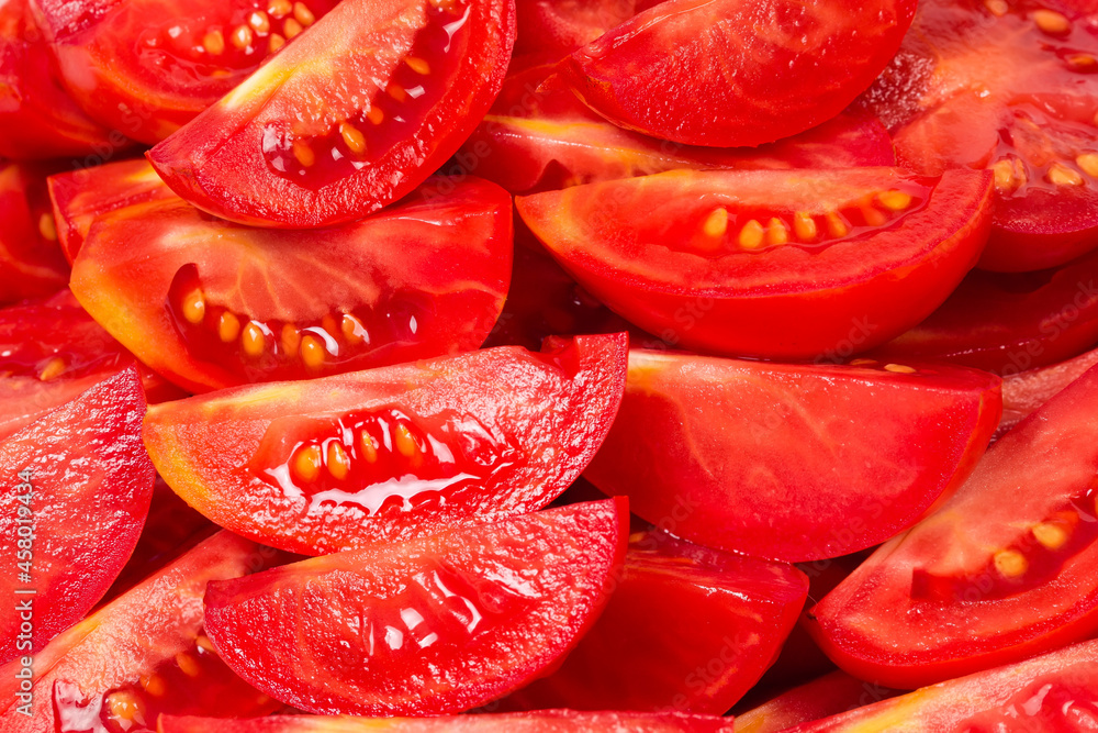 Heap of pieces of the red tomatoes close-up Heap of pieces of the red tomatoes close-up