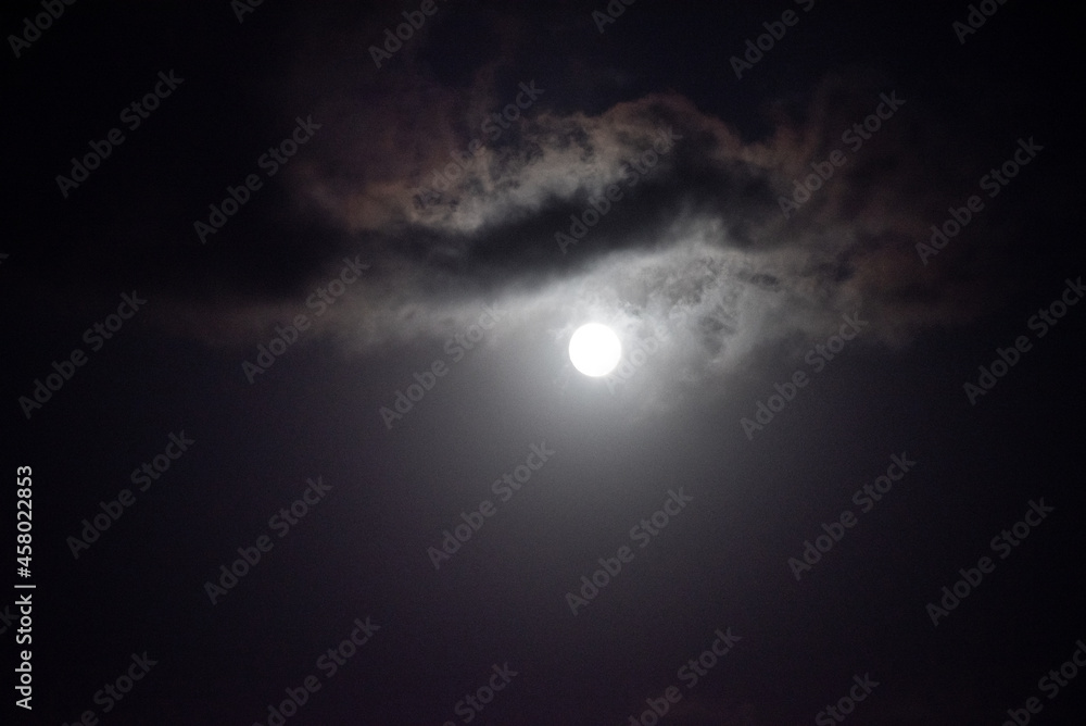 Moon shining in dark night sky