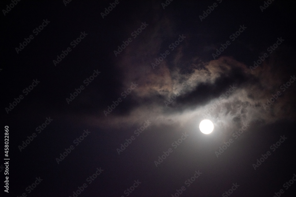 Moon shining in dark night sky