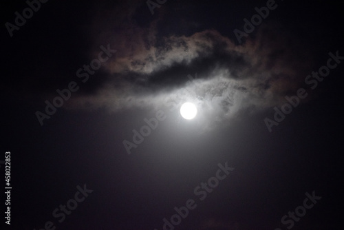 Moon shining in dark night sky