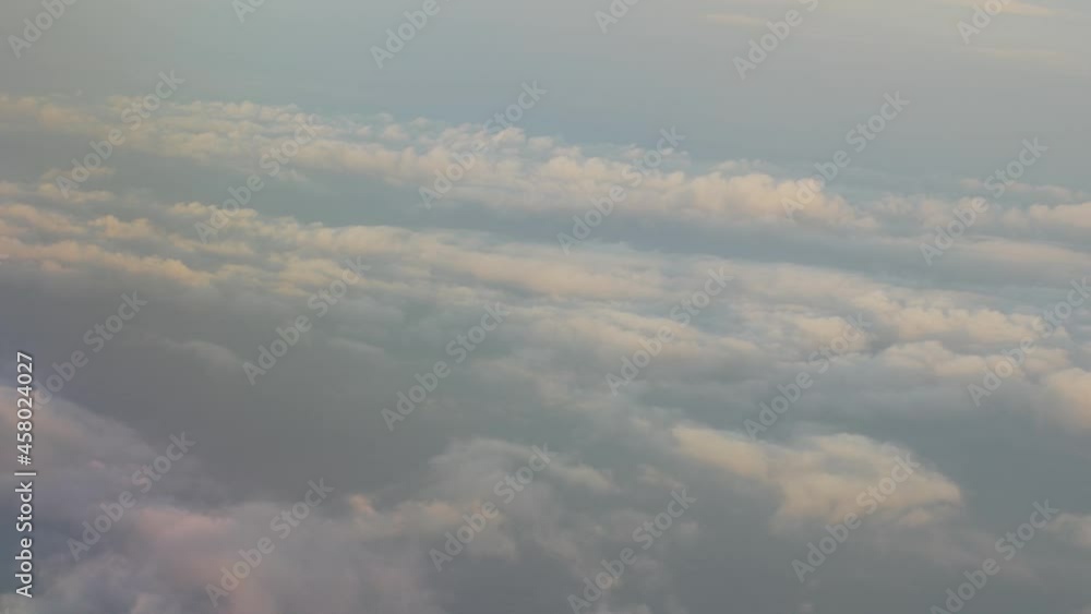 Flying Above Clouds at Sunrise. View from plane window Flying Above Clouds at Sunrise. View from plane window